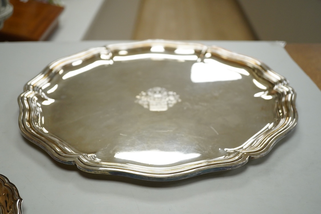 A German 800 standard white metal salver, diameter 35.9cm, together with a similar waiter, diameter 15.6cm, both with engraved armorial, 35oz.
